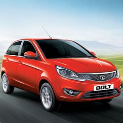 Tata Bolt hatchback taxi parked at RR Tours and Travels Madurai